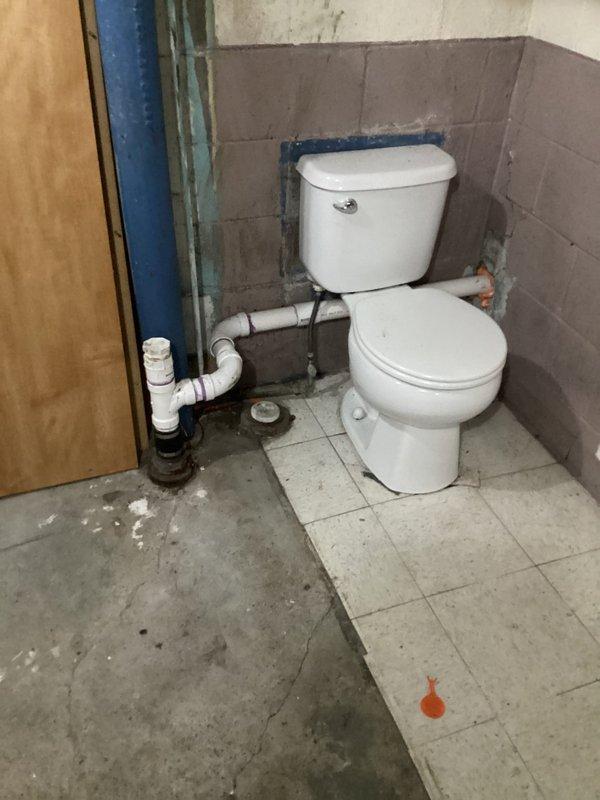 Completed rough-in plumbing installation for basement bathroom, including toilet placement and PVC drainage system connections. Customer was on-site during work; technician Nick will return to perform jetting of drain lines to complete the quoted repair.