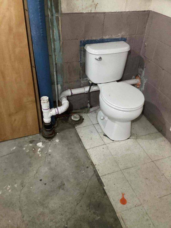 Completed rough-in plumbing installation for basement bathroom, including toilet placement and PVC drainage system connections. Customer was on-site during work; technician Nick will return to perform jetting of drain lines to complete the quoted repair.