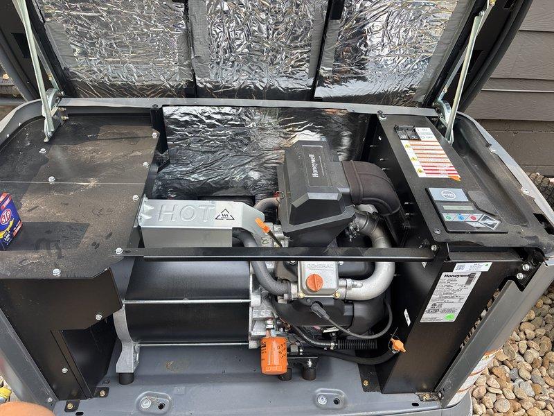 Completed two-year maintenance service on Generac generator with Honeywell control system. Performed comprehensive tune-up including inspection of all mechanical components, refrigerant lines, and electrical connections. Verified proper operation of compressor unit, control box, and safety systems. Inspected gas valve assembly with orange handle lever and associated fuel lines for secure connections and proper function. Checked reflective insulation material and ductwork for integrity. Examined all manufacturer labels and rating plates. Documented internal components and overall system condition through photographic records. Unit tested and confirmed operational. Generator club enrollment processed during visit.
