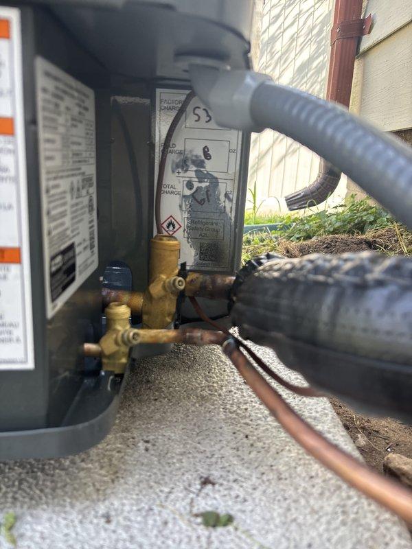 Completed full residential air conditioning system replacement. Installed new outdoor condensing unit on existing concrete pad with proper refrigerant line connections using copper piping and brass service valves. Connected unit to existing Bryant furnace system in basement mechanical room utilizing established ductwork and PVC condensate drainage. Verified all electrical connections, tested system operation, and confirmed proper refrigerant charge levels. System commissioned and left in full operational status.