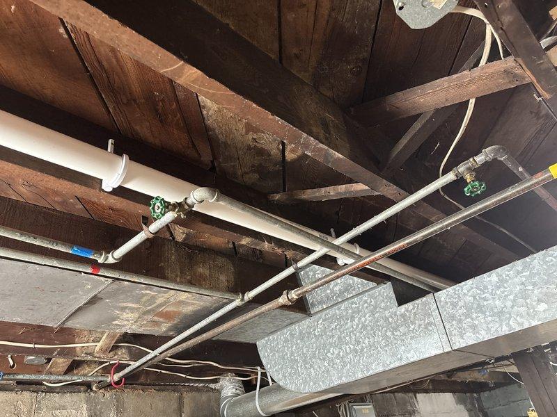 Completed kitchen sink drain repipe and installed client-supplied sink fixture. Removed existing drain lines and installed new PVC drainage piping from sink location through basement ceiling joists to main drain stack. Configured proper venting and secured all piping with appropriate hangers and supports. Mounted new sink, connected supply lines, tested all connections for leaks, and verified proper drainage flow.