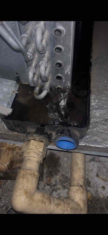 Completed annual ASTU-AC Super Tune-up on 15-year-old air conditioning system, performing comprehensive inspection and maintenance of all major components. Documented equipment condition with photos showing furnace assembly, gas piping connections, and associated mechanical components in basement installation location.