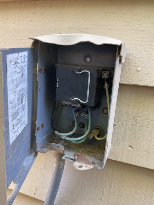 Completed annual AC tune-up on 2020 Amana cooling system. Per customer request, thoroughly cleaned accumulated leaves and debris from inside condenser unit that had been neglected in previous maintenance visits. Inspected electrical disconnect box, noting weathering and corrosion staining consistent with outdoor exposure on 10-year-old equipment; verified proper electrical connections and functionality. Cleaned condenser coils, checked refrigerant levels, tested system operation, and confirmed unit running efficiently. Documented equipment condition with photos of disconnect box and outdoor unit installation area.