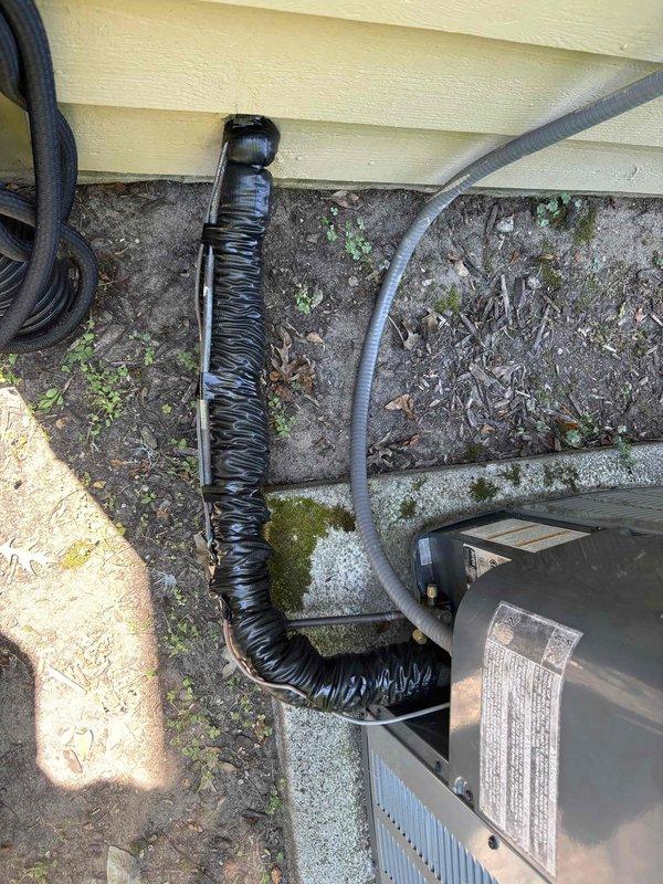 Completed annual AC tune-up on 2020 Amana cooling system. Per customer request, thoroughly cleaned accumulated leaves and debris from inside condenser unit that had been neglected in previous maintenance visits. Inspected electrical disconnect box, noting weathering and corrosion staining consistent with outdoor exposure on 10-year-old equipment; verified proper electrical connections and functionality. Cleaned condenser coils, checked refrigerant levels, tested system operation, and confirmed unit running efficiently. Documented equipment condition with photos of disconnect box and outdoor unit installation area.