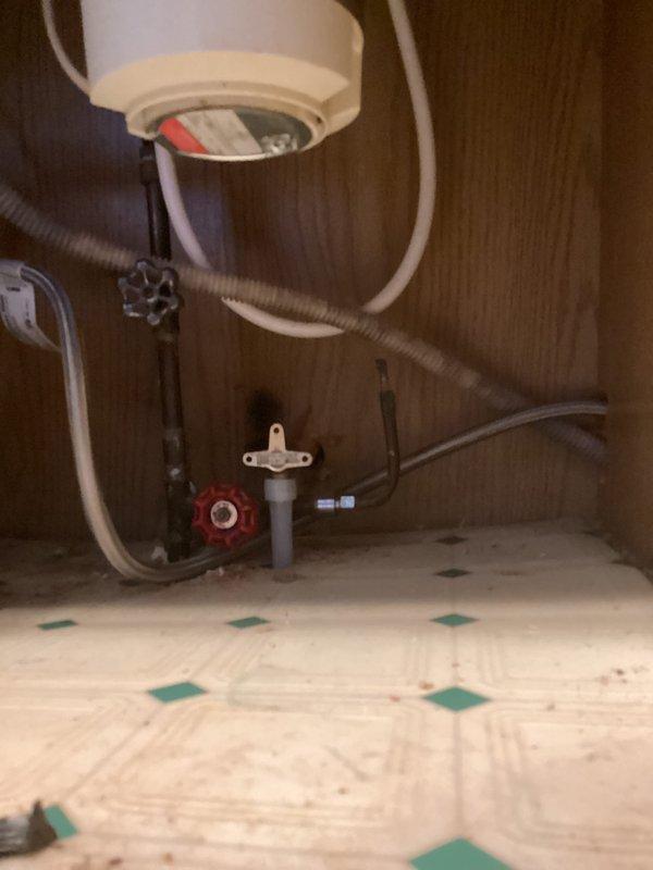 Responded to service call for reported leak at exterior hose bib and water meter in basement of approximately 50-year-old residence. Upon inspection, identified minor weeping at basement water meter connection that had been present for extended period without causing visible damage to surrounding areas or other parts of the home. Examined exterior yard spigot and found slight seepage at packing nut. Tightened packing nut on hose bib to eliminate exterior leak. Assessed water meter leak and determined it required monitoring but posed no immediate safety concerns given its long-standing nature and lack of progression. Inspected visible plumbing infrastructure including water heater connections, copper supply lines, and toilet installation to verify no additional leak points or moisture damage throughout the system. All connections at water heater appeared secure with no evidence of active leaking. Toilet supply line and shut-off valve showed proper operation with no signs of moisture or 