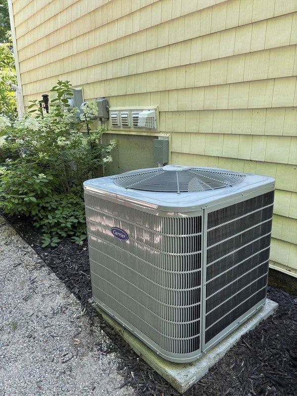 Completed full HVAC system replacement including installation of new Carrier air conditioning condenser unit on exterior concrete pad with proper electrical disconnect, and new air handler unit in basement with associated ductwork and PVC condensate drainage system. All equipment installed per manufacturer specifications, electrical connections verified, refrigerant lines properly charged and tested for leaks, and condensate drain system tested for proper operation. System startup completed, airflow verified, and unit left in full operational condition.