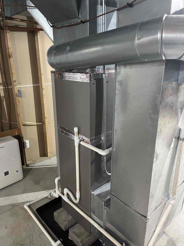 Completed full HVAC system replacement including installation of new Carrier air conditioning condenser unit on exterior concrete pad with proper electrical disconnect, and new air handler unit in basement with associated ductwork and PVC condensate drainage system. All equipment installed per manufacturer specifications, electrical connections verified, refrigerant lines properly charged and tested for leaks, and condensate drain system tested for proper operation. System startup completed, airflow verified, and unit left in full operational condition.