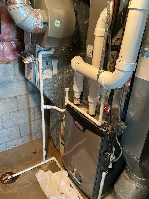 Responded to callback for frozen evaporator coil on 10-year-old Lennox system that continued cooling despite previous service visit. Upon arrival, confirmed indoor coil remained iced with system still operating. Inspected outdoor unit electrical components and verified proper contactor operation and wiring connections. Examined indoor unit and ductwork configuration in mechanical room. System airflow restriction identified as root cause of persistent freezing condition. Thawed coil completely and restored normal system operation with proper temperature differential across evaporator.