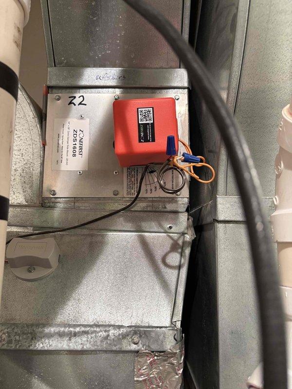 Returned to site to replace failed zone damper motor on HVAC zoning system. Removed defective motor from zone damper assembly and installed new replacement motor, ensuring proper electrical connections to the ZoneFirst ZDS1608 zone control panel. Verified motor operation, confirmed damper movement through full range of motion, and tested system functionality with all zones responding correctly to thermostat calls.