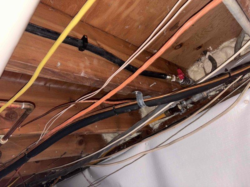 Removed existing gas line and successfully rerouted new gas line for outdoor grill installation. Work was performed in basement/crawl space area, routing new copper gas line along ceiling joists to exterior location. Installation included proper mounting hardware, shutoff valve, and compliance with gas line code requirements for outdoor appliance connection.