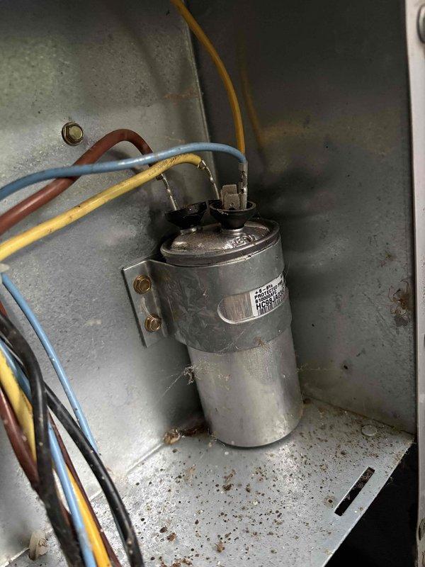# No Cool Service Call

Responded to a no cooling complaint on a 20-year-old system with a non-spinning outdoor fan. Upon arrival, confirmed the indoor temperature was elevated at 80.7°F and the condenser fan motor was inoperative. Performed diagnostic testing of the electrical system and identified a failed run capacitor. Measured voltage and capacitance values, confirming the capacitor was out of specification and preventing the fan motor from starting. Replaced the defective dual run capacitor with a new unit, ensuring proper wire connections to the compressor and fan motor terminals. Verified all electrical connections were secure and tested system operation. Condenser fan motor started successfully, and the system began cooling properly. Monitored system performance to ensure proper operation and temperature reduction. System restored to normal cooling operation.