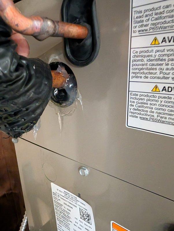 Responded to inspector correction request for suction line grommet installation and insulation adjustment. Installed missing grommet on suction line penetration through equipment panel to prevent condensate dripping onto furnace below. Pushed line insulation tight to evaporator coil to ensure proper seal and drainage control. Documented completed corrections with photos showing proper grommet installation and sealed penetration points on copper refrigerant lines.