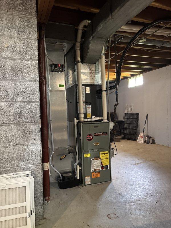 Completed full air conditioning system installation including outdoor condensing unit and associated components. Installed Rheem condensing unit on concrete pad with proper clearances from structure, connected refrigerant lines and electrical service. Routed and secured PVC condensate drain lines from indoor evaporator coil to exterior discharge point. Integrated new evaporator coil with existing furnace system in basement, ensuring proper airflow and refrigerant line connections through foundation. Verified all electrical connections, tested system startup and operation, confirmed proper refrigerant charge and system pressures. Coordinated Michigan Saves financing documentation through electronic signature platform for project approval and processing.