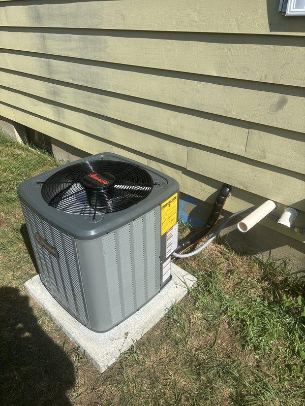 Completed full air conditioning system installation including outdoor condensing unit and associated components. Installed Rheem condensing unit on concrete pad with proper clearances from structure, connected refrigerant lines and electrical service. Routed and secured PVC condensate drain lines from indoor evaporator coil to exterior discharge point. Integrated new evaporator coil with existing furnace system in basement, ensuring proper airflow and refrigerant line connections through foundation. Verified all electrical connections, tested system startup and operation, confirmed proper refrigerant charge and system pressures. Coordinated Michigan Saves financing documentation through electronic signature platform for project approval and processing.