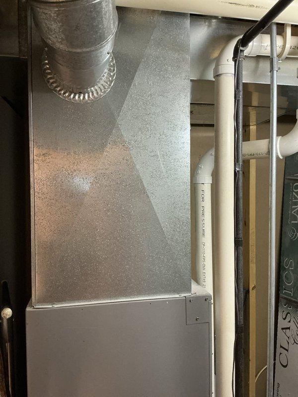 Completed estimate for adding air conditioning system to existing property. Inspected mechanical closet containing current air handler unit and assessed existing ductwork infrastructure in attic space. Evaluated copper refrigerant line routing, available electrical capacity, and condensate drainage requirements. Documented existing HVAC equipment configuration, duct plenum connections, and available space for new AC condenser placement. Photographed mechanical room layout showing air handler positioning, exposed wall framing for potential line set penetration, and overhead ductwork with plenum connections displaying moisture condensation patterns indicating current system operation.