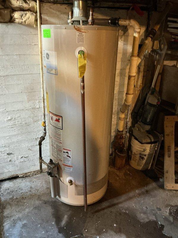 Conducted estimate for water heater replacement at client's request. Assessed existing GE water heater installation in basement utility area, documenting current configuration including copper and PVC supply lines, metallic exhaust venting, and connections to home plumbing system. Photographed unit specifications, manufacturer labels, and surrounding plumbing infrastructure to provide accurate replacement quote for client-selected water heater model.