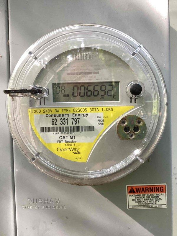 Conducted site assessment for standby generator installation estimate. Documented existing electrical infrastructure including 200-amp service panel with Consumers Energy meter and main distribution panel with circuit directory. Evaluated current electrical service capacity and panel configuration to determine generator integration requirements. Photographed utility meter specifications showing 240V 3-wire service with digital metering and existing load center with dual breaker rows for load calculation purposes. Assessment completed to provide accurate pricing for Kohler standby generator system installation including necessary transfer switch and electrical connections to existing service.