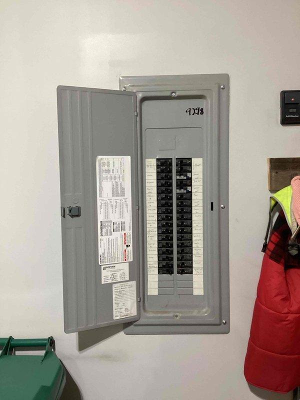 Conducted site assessment for standby generator installation estimate. Documented existing electrical infrastructure including 200-amp service panel with Consumers Energy meter and main distribution panel with circuit directory. Evaluated current electrical service capacity and panel configuration to determine generator integration requirements. Photographed utility meter specifications showing 240V 3-wire service with digital metering and existing load center with dual breaker rows for load calculation purposes. Assessment completed to provide accurate pricing for Kohler standby generator system installation including necessary transfer switch and electrical connections to existing service.