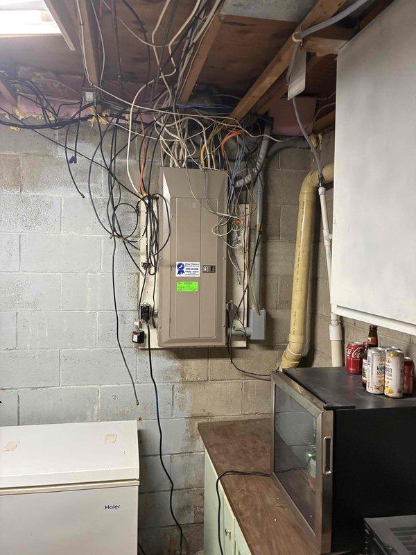 Conducted comprehensive site assessment for standby generator installation in basement utility area. Evaluated existing electrical infrastructure including main service panel, available clearances, and wiring configuration to determine optimal generator placement and connection requirements. Documented current electrical panel setup with multiple circuits and measured available wall space for generator transfer switch installation. Assessed basement access points, ventilation requirements, and proximity to gas service line for natural gas or propane fuel connection. Photographed existing water heater and mechanical systems to develop bundled proposal for generator system alongside water heater replacement and previously quoted electrical work.