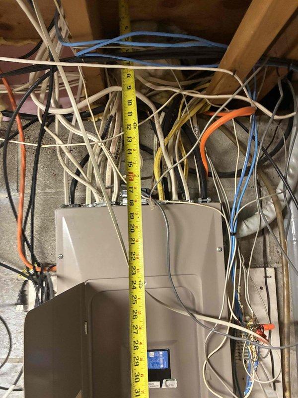 Conducted comprehensive site assessment for standby generator installation in basement utility area. Evaluated existing electrical infrastructure including main service panel, available clearances, and wiring configuration to determine optimal generator placement and connection requirements. Documented current electrical panel setup with multiple circuits and measured available wall space for generator transfer switch installation. Assessed basement access points, ventilation requirements, and proximity to gas service line for natural gas or propane fuel connection. Photographed existing water heater and mechanical systems to develop bundled proposal for generator system alongside water heater replacement and previously quoted electrical work.