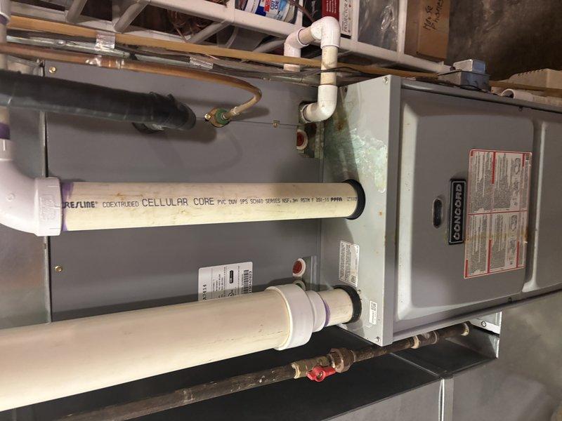 Responded to no cooling complaint at residential property. Upon arrival, inspected Goodman furnace system located in basement mechanical room. Performed diagnostic evaluation of HVAC unit including visual inspection of manufacturer specification labels, wiring connections, and system components. Verified furnace model information and reviewed technical specifications including heating demand sequences, combustion air inducer operation, ignitor circuit, gas valve function, and indoor blower motor settings. Examined PVC intake and exhaust venting configuration for proper installation and clearances. Checked copper refrigerant lines, condensate drainage piping, and electrical connections to unit. Documented equipment condition and system specifications with photographs for service records. System evaluated and findings recorded for cooling system troubleshooting.