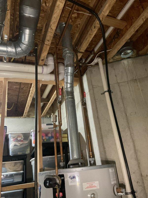 Provided estimate for replacement of 50-gallon Bradford White automatic storage water heater experiencing slow leak. Documented existing unit specifications, venting configuration with metallic flue pipe, copper supply line connections with shut-off valves, and installation location in unfinished basement utility area.