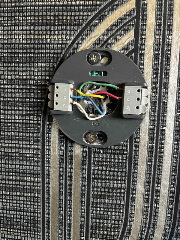 Responded to cooling complaint where thermostat set to 68°F would not maintain temperature. Accessed property using key located in cellar rafters as homeowner was unavailable. Inspected thermostat wiring configuration showing proper connections for Y, C, W, G, R, and OB terminals with appropriate low-voltage wiring. Evaluated HVAC air filter condition and found significant dust and dirt accumulation restricting airflow. Replaced dirty pleated filter with clean unit to restore proper system airflow and cooling capacity. System should now maintain set temperature effectively.