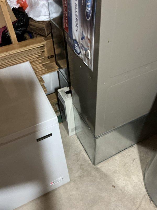 Completed comprehensive tune-up service on 25-year-old residential air conditioning system located in basement utility area. Performed standard maintenance procedures including inspection of furnace unit, ductwork connections, and HVAC components to ensure proper system operation and efficiency.