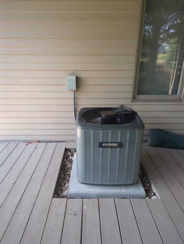 Completed full HVAC system replacement including outdoor condensing unit and indoor air handler. Installed new Carrier furnace system in basement utility area with proper ductwork connections, electrical disconnect, and PVC condensate drain lines. Mounted exterior condenser unit on concrete pad with electrical conduit run and disconnect box properly secured to exterior wall, ensuring all components meet manufacturer specifications and local code requirements.
