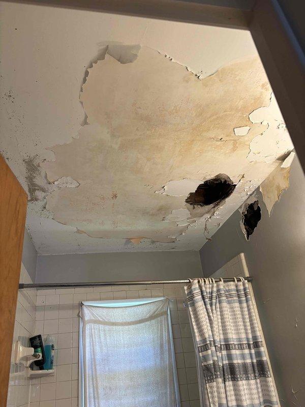 # Bathroom Exhaust Fan Installation Assessment

Responded to customer request for bathroom ventilation fan installation. Upon arrival, conducted thorough assessment of bathroom conditions to determine proper installation requirements and feasibility.

Inspection revealed significant pre-existing water damage to bathroom ceiling, including extensive brown water staining, deteriorated drywall with multiple areas of material failure, and exposed structural cavities. The ceiling showed signs of prolonged moisture intrusion with compromised ceiling material in multiple locations throughout the space.

Due to the severe structural damage and unsafe ceiling conditions, recommended that water damage remediation and ceiling repair be completed prior to proceeding with exhaust fan installation. Explained that proper ventilation fan mounting requires structurally sound ceiling material and access to secure framing members, which cannot be safely achieved with current ceiling deterioration.

Docum