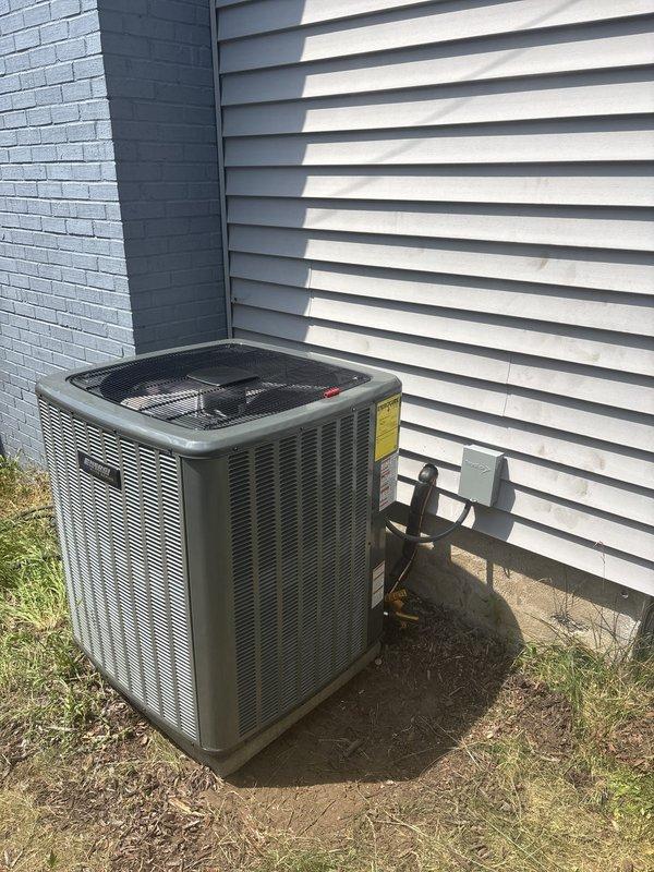 Completed full HVAC system installation including indoor air handler unit positioned in basement mechanical room and outdoor condensing unit mounted on concrete pad at building exterior. Installed new refrigerant lines, electrical connections, condensate drainage, and PVC venting system per manufacturer specifications. System tested and verified operational with all safety labels and documentation properly affixed to equipment.
