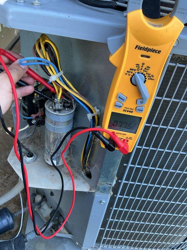 Completed comprehensive Super Tune-up service on 10-year-old residential air conditioning system. Performed electrical diagnostics using Fieldpiece multimeter, measuring capacitor performance and verifying proper voltage readings at 24.5V across system components. All electrical connections inspected, tested, and confirmed to be functioning within manufacturer specifications with no signs of deterioration or required repairs.