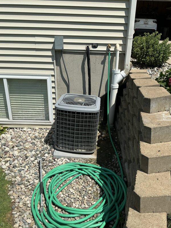 Completed furnace and air conditioning estimate for a residential system with a 22-year-old outdoor condensing unit. Performed comprehensive AC tune-up and system evaluation, documenting equipment condition through photographs of both the exterior condenser unit with protective cage and the interior basement mechanical room housing the furnace and air handler. Assessment focused on repair costs versus equipment age to provide replacement recommendations, with Friends and Family discount applied to the tune-up service.