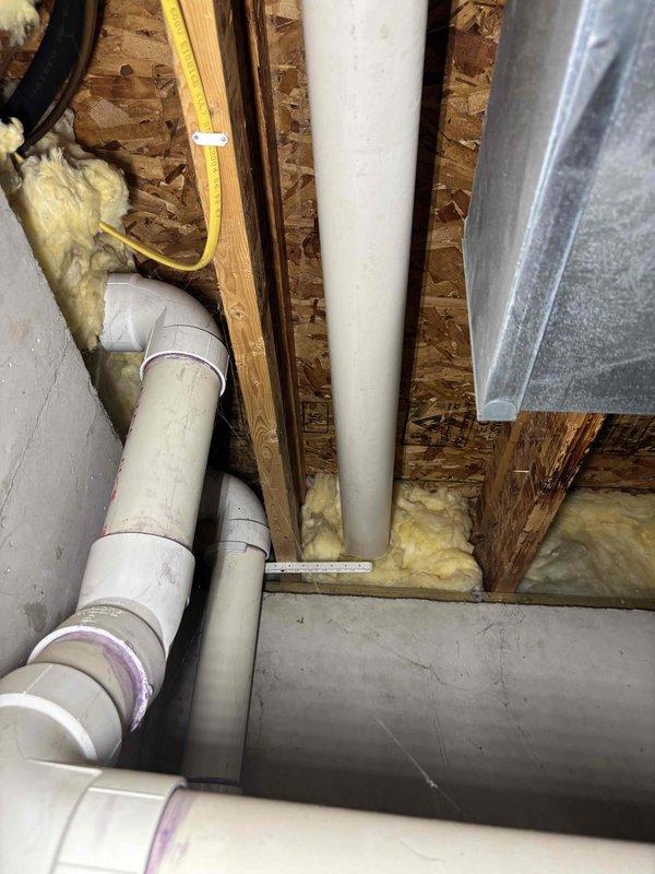 Provided estimate for replacement of 21-year-old power vented natural gas water heater (50-gallon capacity) in single family residence. Documented existing plumbing configuration including copper supply lines with visible corrosion and oxidation on fittings, existing venting system with PVC components, and current mechanical room layout to determine replacement specifications and installation requirements.