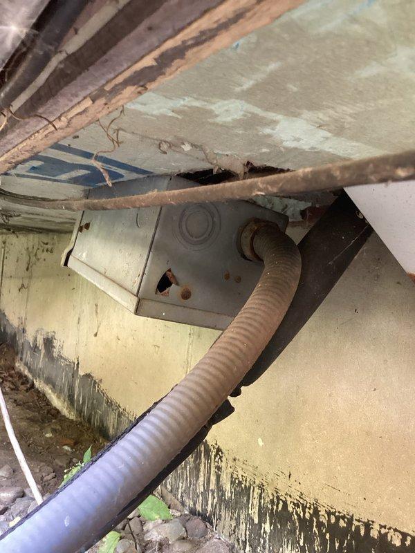 Responded to service call for air conditioning system not cooling. Upon arrival, connected diagnostic equipment to evaluate system performance. Used Fieldpiece digital manifold to measure refrigerant pressures and temperatures on 24-year-old R-22 system. Diagnostic readings revealed system operating parameters including superheat and subcooling values. 

Inspected condensate drainage system in basement area, noting flexible corrugated drain line routing through structural space. Observed significant moisture damage and deterioration on basement walls with paint peeling and water staining, indicating possible long-term drainage or moisture issues in the area. Documented equipment readings and site conditions with photographs for service records.

Completed diagnostic evaluation and provided customer with findings regarding cooling system performance. Also discussed customer's additional request for chimney cap installation estimate as separate scope of work.