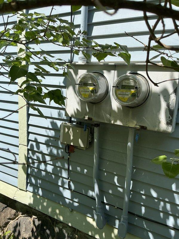 Conducted comprehensive electrical service evaluation for century-old two-story duplex to assess current system capacity and code compliance in preparation for potential mini-split air conditioning installation in upper unit. Inspected existing dual-meter configuration, service entrance conductors, exterior conduit runs, and main electrical panels to determine adequacy of current amperage rating and identify necessary upgrades to support increased electrical loads and meet current National Electrical Code requirements.