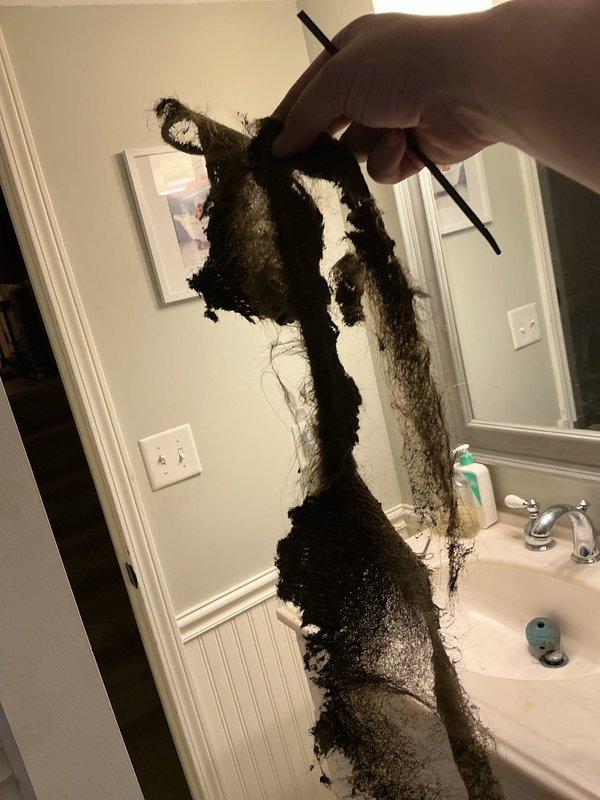 Responded to callback for recurring water leak on 8-year-old Goodman unit following previous day's condensate pump replacement under recall. Upon inspection, discovered severely clogged and deteriorated drain pan with extensive biological growth and standing water accumulation. Drain line was completely obstructed with heavy black mold and debris buildup, preventing proper condensate drainage. Removed and documented contaminated drain line material showing advanced decomposition. Thoroughly cleaned drain pan, removing all standing water, sediment, and microbial growth from interior surfaces. Cleared primary and secondary drain lines to restore proper water flow. Verified drain system functionality and confirmed no active leaks present at completion of service.