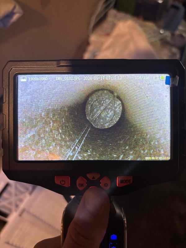 Responded to no cooling complaint on six-year-old HVAC system. Performed diagnostic inspection using borescope camera to examine internal ductwork and system components. Camera inspection revealed significant buildup, discoloration, and debris accumulation within the ductwork and on critical system components, indicating restricted airflow and potential blockage issues affecting system performance. Documented findings with photographic evidence showing yellowish-green and brown deposits, dark staining, and weathered surfaces throughout the inspected areas. The extensive contamination and buildup identified would prevent proper system operation and airflow distribution.