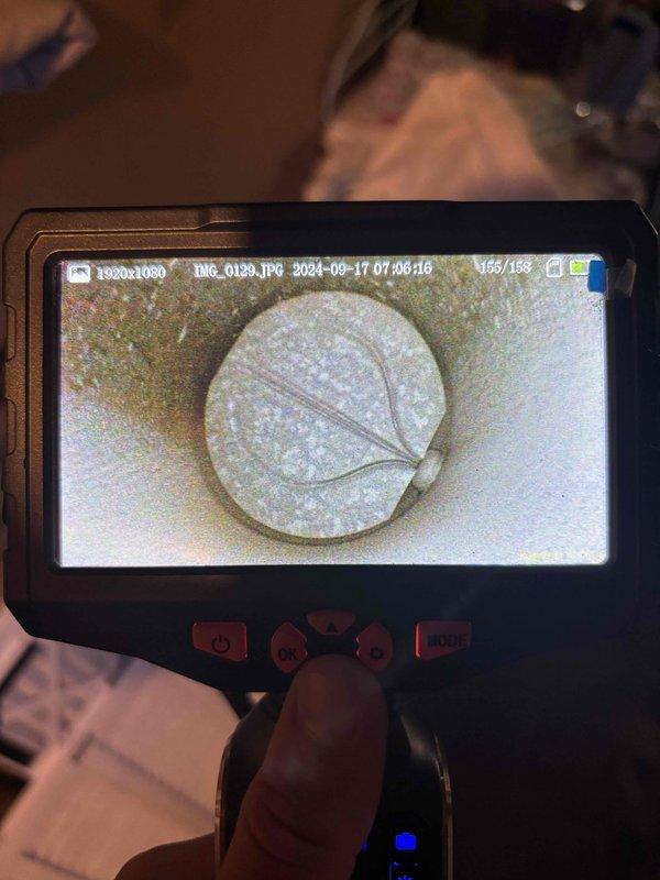 Responded to no cooling complaint on six-year-old HVAC system. Performed diagnostic inspection using borescope camera to examine internal ductwork and system components. Camera inspection revealed significant buildup, discoloration, and debris accumulation within the ductwork and on critical system components, indicating restricted airflow and potential blockage issues affecting system performance. Documented findings with photographic evidence showing yellowish-green and brown deposits, dark staining, and weathered surfaces throughout the inspected areas. The extensive contamination and buildup identified would prevent proper system operation and airflow distribution.