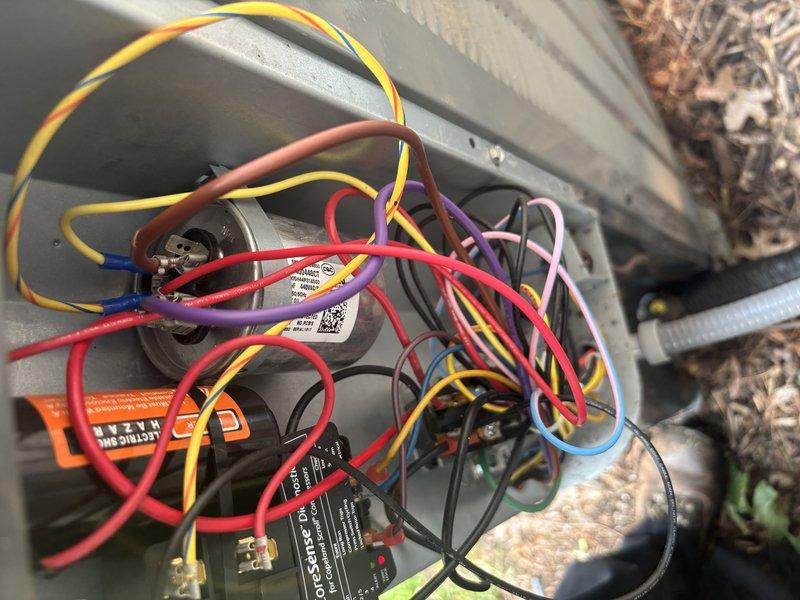 Responded to no cooling complaint on 2022 EnergiAir WT 12-2034 unit. Upon inspection, discovered failed low voltage wire connection preventing proper communication between thermostat and outdoor unit. Replaced defective yellow control wire with new connector ends, restored electrical continuity to control circuit, and verified all wire connections secure within junction box. System tested and confirmed cooling operation restored to normal parameters.