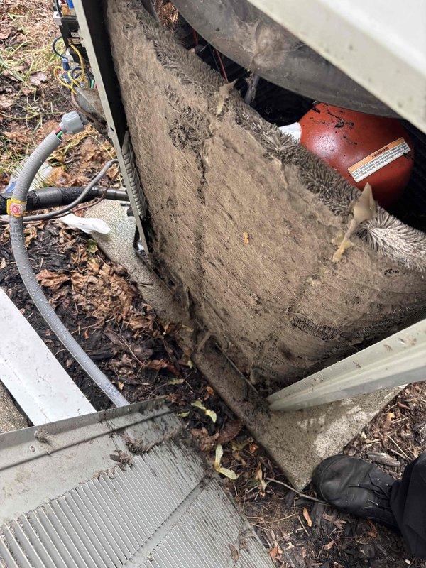 Responded to no cooling call on 24-year-old American Standard system. Upon inspection, found outdoor condensing unit heavily obstructed with leaves, twigs, and organic debris accumulating around and within the unit compartment. Debris buildup was restricting airflow to the condenser coil and compromising system performance. Cleaned condensing unit area, removing all accumulated debris from compartment and surrounding components. Inspected 16x25x1 air filter at indoor air handler, which showed normal wear. Cleared all obstructions from outdoor unit, restored proper airflow to condenser coil, and verified system operation. Unit returned to normal cooling function after debris removal.