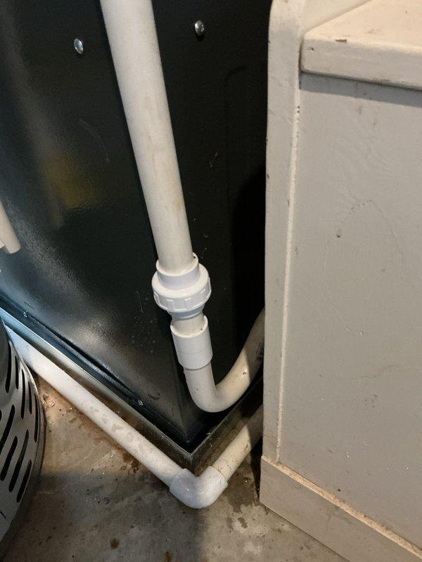 Completed annual cooling maintenance and tune-up on 15-year-old residential air conditioning system. Upon inspection, discovered evaporator coil heavily frosted with ice accumulation, indicating restricted airflow or potential refrigerant issue. Examined condensate drain system with white PVC piping in mechanical space, confirmed proper drainage function. Documented frost buildup on coil surface and noted minor corrosion on copper components within unit. System requires follow-up evaluation to determine root cause of icing condition, which may include low refrigerant charge, dirty air filter, or blower motor malfunction.