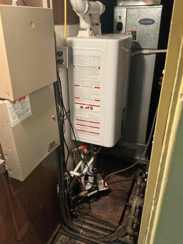Completed yearly maintenance on wall-mounted Navien tankless water heater with no reported issues. Performed comprehensive tune-up including inspection of all plumbing connections, gas lines, venting system, and electrical components. Flushed unit to remove mineral buildup, verified proper operation of all valves and safety devices, checked combustion chamber and heat exchanger, and confirmed adequate venting through PVC exhaust pipe. Unit tested and operating within manufacturer specifications upon completion.