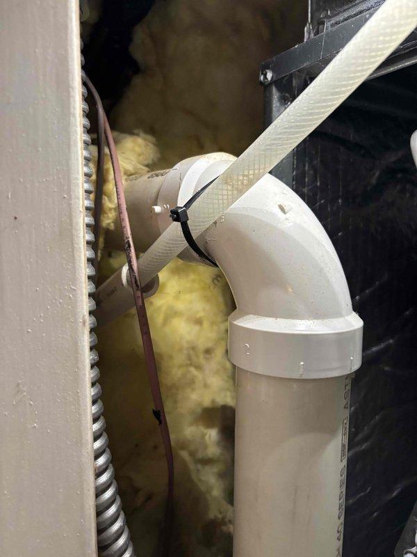 Responded to complaint of intermittent cooling failure affecting entire home after approximately one hour of operation on seven-year-old EnergiAir system. Previous technician visit found unit operational at time of inspection. Upon arrival, confirmed best contact number and proceeded with comprehensive system evaluation. Inspected condensate drain system and discovered failed drain float switch causing safety shutdown when triggered. Removed defective threaded rod-style float switch assembly from drain line. Examined PVC condensate piping, drain pan connections, and associated safety components in mechanical space. Replaced faulty float switch with new assembly to restore proper condensate overflow protection. Verified drain line flow, tested system operation through multiple cooling cycles exceeding one hour to confirm intermittent shutdown issue resolved. Unit now cooling properly without safety interruptions.