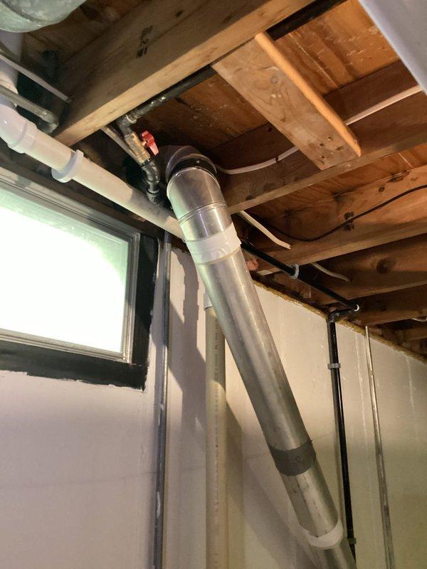 Completed re-routing of gas line to dryer location in basement area. Installed new black iron gas piping with proper support brackets and red-handled shut-off valve, running line along ceiling joists to new dryer position. All work performed to code specifications with pressure testing completed and verified leak-free operation.
