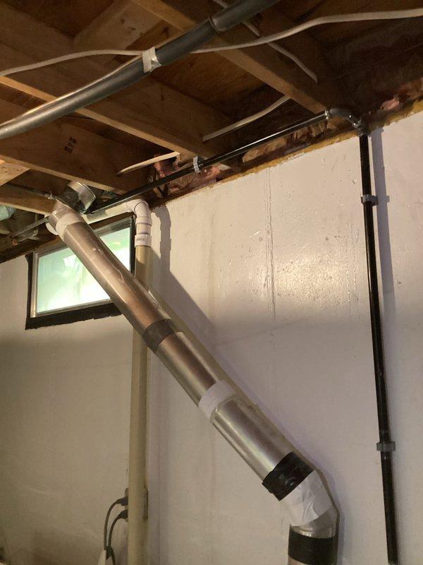 Completed re-routing of gas line to dryer location in basement area. Installed new black iron gas piping with proper support brackets and red-handled shut-off valve, running line along ceiling joists to new dryer position. All work performed to code specifications with pressure testing completed and verified leak-free operation.