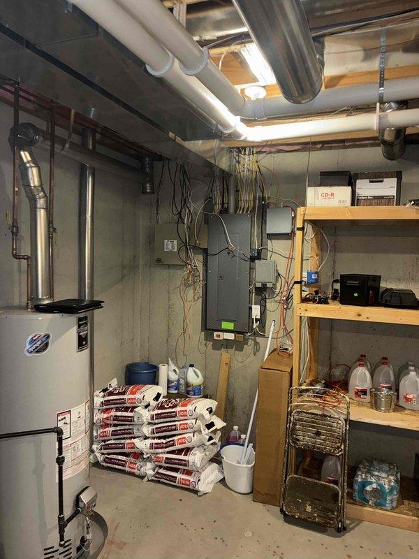 Conducted comprehensive site assessment for whole home generator installation at a 24-year-old residential property with no existing backup power system. Evaluated basement electrical infrastructure, including main service panel, existing electrical loads, and available installation space. Documented current utility room configuration with water heater, electrical distribution equipment, and existing conduit pathways to determine optimal generator placement and transfer switch location. Assessed concrete wall mounting options and overhead clearances for required electrical connections and automatic transfer switch installation.