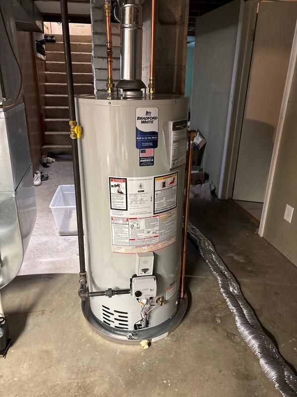Completed full replacement of residential air conditioning system and water heater. Installed new AC condenser unit on existing concrete pad with proper electrical disconnect and refrigerant line connections to exterior wall. Replaced existing water heater with new Bradford White unit in basement location, including proper venting, gas line connections, and copper supply piping with appropriate fittings and safety controls.