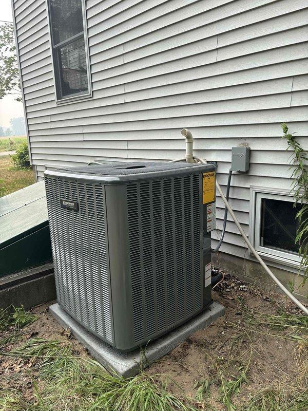 Completed full air conditioning system replacement including outdoor condensing unit and indoor air handler. Installed new Carrier HVAC equipment with proper refrigerant line connections, electrical disconnect, condensate drainage system with PVC piping configuration, and integrated ductwork connections. System tested and verified operational upon completion.