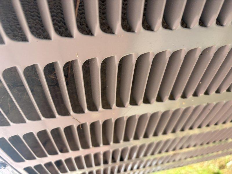 Responded to thermostat issue where unit was set to 73°F but home temperature remained at 80°F with air blowing but no cooling. Inspected evaporator coil and found dust accumulation within fin spaces affecting heat transfer efficiency. Examined electrical components including capacitor and relay connections in outdoor unit, verified all wire connections were secure and capacitor was functioning within specifications.